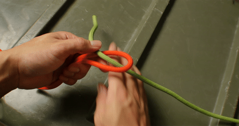 Illustrates the process of passing the smaller rope through the bight and completing the knot.
