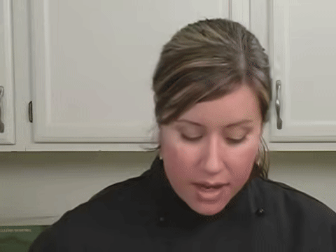 Shows adding cucumber as a filling onto the rice.