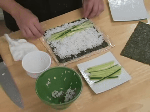 Demonstrates using the B&B mat to roll the sushi tightly.