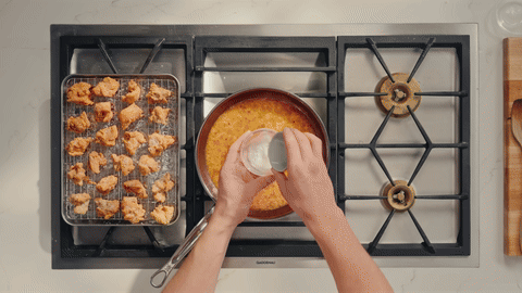 Shows adding cornstarch slurry to the sauce and thickening it.