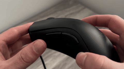 Shows the use of compressed air to clean the mouse wheel.