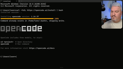 Displays the terminal with the 'OpenCode' command being entered and executed.