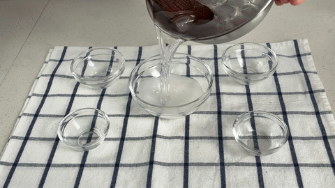 Demonstrates mixing the marinating ingredients and pouring them over the beef.