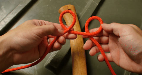 Demonstrates positioning the loops over each other and securing them on the object.