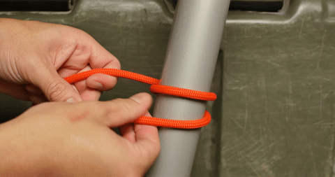 Illustrates the process of tying two half hitches to secure the round turn.