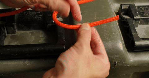 Shows the initial loop formation by passing the rope through the attachment point.