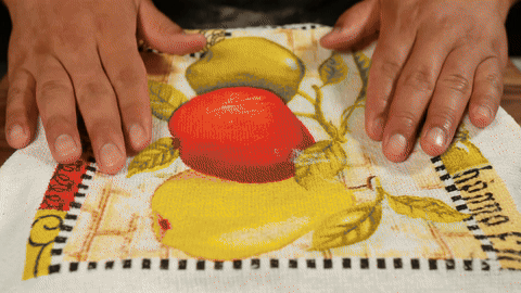 Illustrates applying egg wash and placing rolls in the oven.