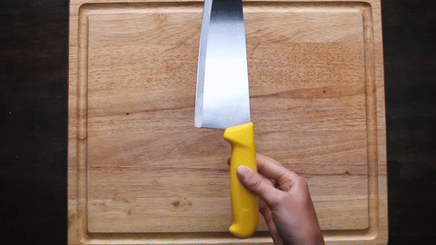 Shows the correct hand positioning for gripping the knife.