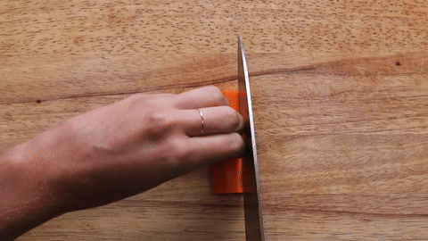 Demonstrates slicing a carrot into matchsticks.