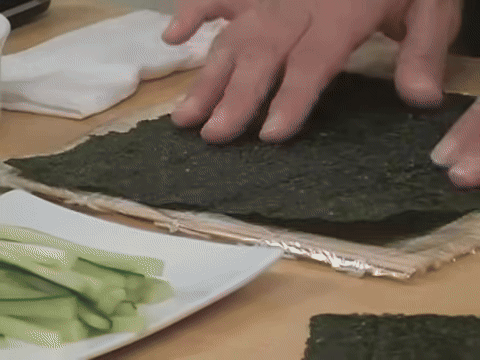 Demonstrates placing the seaweed and checking its quality based on color.