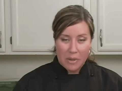 Shows cutting the sushi roll into even pieces.