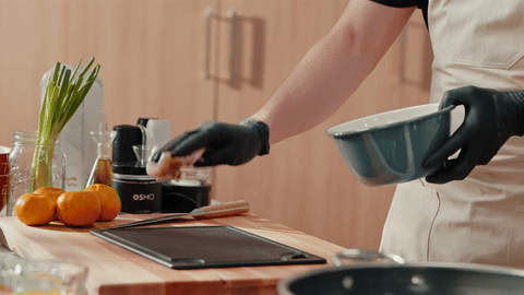 Demonstrates cutting chicken into bite-sized pieces.