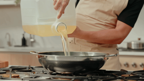 Shows oil being heated in a pan to the correct temperature.