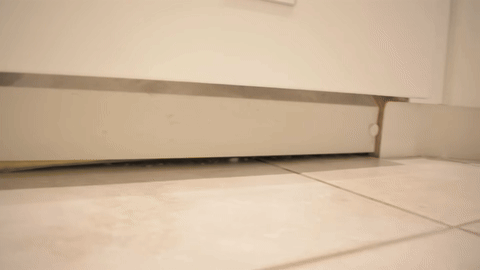 Demonstrates the removal of the dishwasher cover by unscrewing bolts.