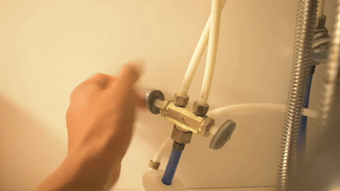 Shows the process of shutting off the water supply valve.