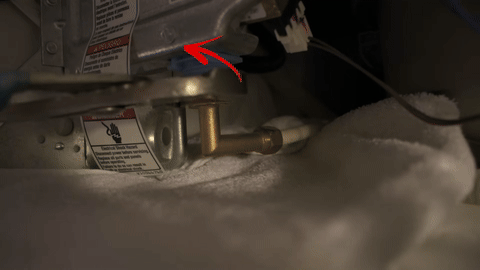 Demonstrates the disconnection of water and disposal lines with a towel in place.