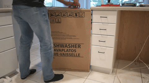 Shows the preparation of the new dishwasher, including checking components and removing the bottom panel.