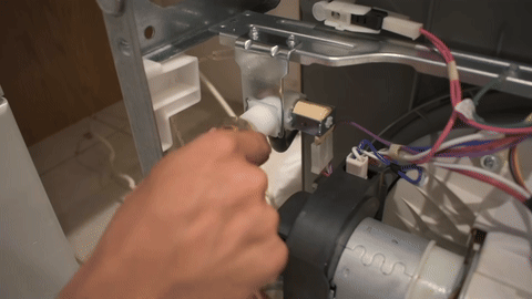 Demonstrates the attachment of the water supply and drain hose.