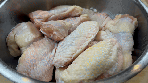 Shows the process of mixing marinade ingredients with the wings.