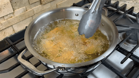Shows wings being removed from oil and resting.