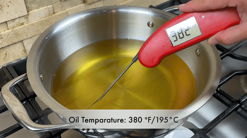 Shows the second frying of the wings.