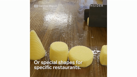 The process of shaping butter into molds.