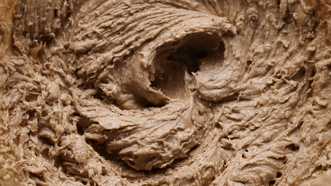 Adding egg and egg yolk to the mixture.