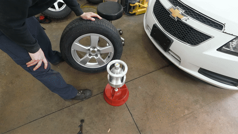 Shows the tire being reinstalled onto the vehicle.