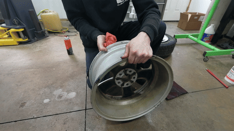 Shows cleaning the rim with a scotch bright pad.