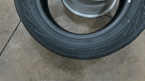 Shows the process of mounting the new tire onto the rim.