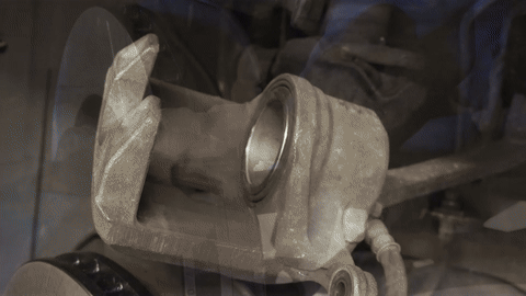 Illustrates the lubrication of caliper pins.