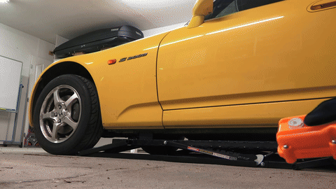 Illustrates lowering the car and torquing lug nuts.