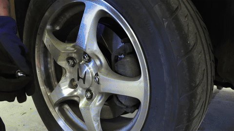 Shows the process for rear brakes with parking brake considerations.