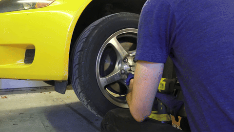 Shows the removal of wheels to access the brake system.