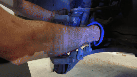 Shows the removal of brake pads from the caliper.