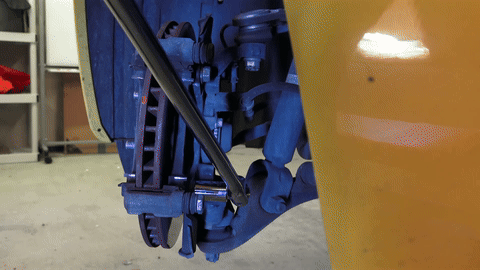 Demonstrates the removal of the caliper bracket.