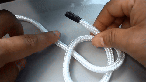 Shows the rope end being positioned behind the middle portion.