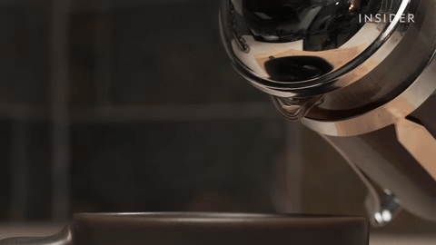 Shows pouring the coffee into a cup.