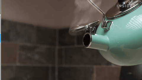 Shows pouring boiling water into the French press.