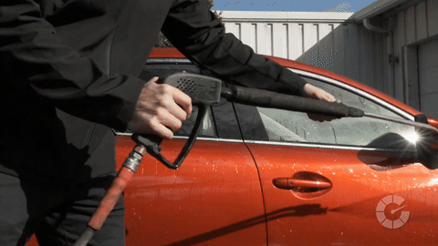Shows the process of washing and drying the car to prepare the surface.