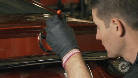 Illustrates inspecting and cleaning details with a brush and spray wax.