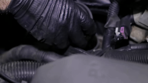 Pouring new oil into the engine and replacing the fill cap.