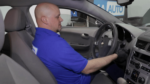 Checking the oil level with the dipstick after running the engine.