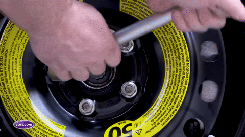 Lowering the car and removing the jack.