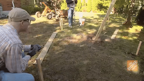 Shows repositioning and bracing the post with wood.