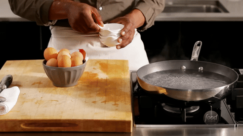 Shows the process of reducing the heat to a simmer.