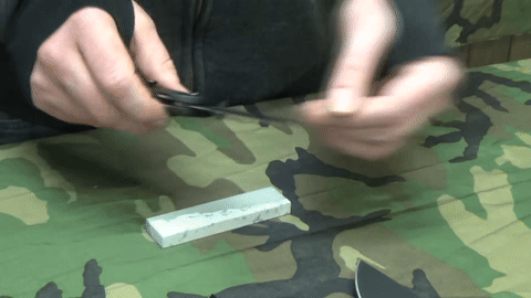 Using a coarse stone to address flat spots on the blade.