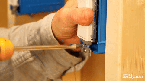 Installing the second switch into the electrical box.