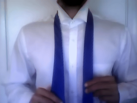 Demonstrates wrapping the wide end around the narrow end, ending with the wide end in front.