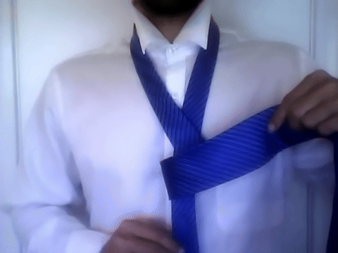 Shows the wide end being pushed through the loop at the neck.